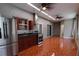 A kitchen area featuring stainless steel appliances, wood cabinets, tile flooring, and modern lighting at 2300 Dawnwood Ln, Orlando, FL 32809