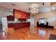 Spacious living room featuring hardwood floors, a decorative chandelier, and an open layout at 2300 Dawnwood Ln, Orlando, FL 32809