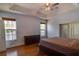 Spacious main bedroom featuring hardwood floors, two windows and a ceiling fan at 2300 Dawnwood Ln, Orlando, FL 32809