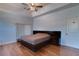 Bright main bedroom showcasing hardwood floors, ceiling fan and modern platform bed at 2300 Dawnwood Ln, Orlando, FL 32809