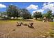 Spacious backyard featuring a fire pit with Adirondack chairs and a playset at 23520 San Sebastian Ct, Sorrento, FL 32776