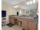 Bathroom with double vanity, granite countertop, shower, tub and a large mirror at 23520 San Sebastian Ct, Sorrento, FL 32776