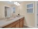 Bright bathroom featuring double sinks with modern fixtures and large mirrors at 23520 San Sebastian Ct, Sorrento, FL 32776