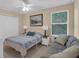Well-lit bedroom features a bed, sofa, and neutral decor at 23520 San Sebastian Ct, Sorrento, FL 32776