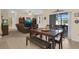 Cozy dining area with access to the living room and screened in patio at 23520 San Sebastian Ct, Sorrento, FL 32776