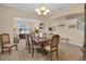 Inviting dining room with a chandelier, large window, and classic decor, perfect for Gathering meals and gatherings at 23520 San Sebastian Ct, Sorrento, FL 32776