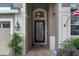 Inviting front entrance with a decorative glass door, sidelights, manicured landscaping, and an outdoor lantern at 23520 San Sebastian Ct, Sorrento, FL 32776