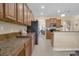 Kitchen showcasing granite countertops, ample cabinetry, and stainless steel appliances at 23520 San Sebastian Ct, Sorrento, FL 32776