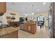Well-appointed kitchen with stone countertops, stainless steel appliances, and a seamless transition to the adjacent living area at 23520 San Sebastian Ct, Sorrento, FL 32776