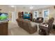 Inviting living room featuring comfortable seating, ceiling fan, and large windows at 23520 San Sebastian Ct, Sorrento, FL 32776