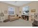 Cozy playroom with neutral tones, a comfy sofa, ample natural light, and kid-friendly decor for creative play at 23520 San Sebastian Ct, Sorrento, FL 32776