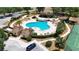 A captivating aerial view of a community pool, enhanced by well-maintained landscaping and inviting amenities at 23520 San Sebastian Ct, Sorrento, FL 32776