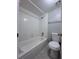 Neat bathroom with a tiled shower and tub combination, complemented by a toilet and a towel bar at 2426 Branch Way # 200, Maitland, FL 32751
