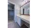 Bright bathroom with vanity, makeup counter, large mirror, and access to a closet for added storage at 2426 Branch Way # 200, Maitland, FL 32751