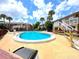 Large community pool surrounded by palm trees and condos in a tranquil setting at 2426 Branch Way # 200, Maitland, FL 32751