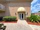Brick building with a tan awning above the double door entrance, and manicured landscaping, and a brick walkway at 2426 Branch Way # 200, Maitland, FL 32751