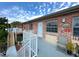 Balcony view of brick building with white trim, an outdoor chair, and stairs with a sunny blue sky at 2426 Branch Way # 200, Maitland, FL 32751