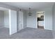 Inviting living room with neutral tones, carpet, and a seamless flow to the kitchen at 2426 Branch Way # 200, Maitland, FL 32751
