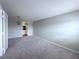 Open living room with neutral carpet, fresh paint, and modern light fixture at 2426 Branch Way # 200, Maitland, FL 32751