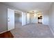 Spacious, carpeted living room with neutral colors, bright lighting, and easy access to the kitchen and bedrooms at 2426 Branch Way # 200, Maitland, FL 32751