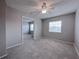 Relaxing main bedroom has carpet, ceiling fan, and a window providing natural light, plus an en-suite bathroom at 2426 Branch Way # 200, Maitland, FL 32751