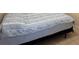 Close-up of bed with striped bedding and blue comforter at 2612 Shantiniketan Blvd # G12, Tavares, FL 32778