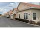 Exterior of a row of cream-colored villas with terra cotta roofs and well-maintained landscaping along a paved road at 2612 Shantiniketan Blvd # G12, Tavares, FL 32778