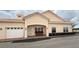 Inviting exterior featuring a light tan color scheme, red tiled roof, and attached garage at 2612 Shantiniketan Blvd # G12, Tavares, FL 32778