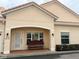 Front view of the home showcasing a charming entrance and manicured landscaping with bench at 2612 Shantiniketan Blvd # G12, Tavares, FL 32778