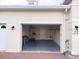 Attached garage showing a glimpse of ample storage and functionality of the space at 2612 Shantiniketan Blvd # G12, Tavares, FL 32778