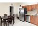 Tile floor kitchen with stainless steel refrigerator at 2612 Shantiniketan Blvd # G12, Tavares, FL 32778