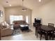 Open-concept living space with large windows and comfortable seating arrangements at 2612 Shantiniketan Blvd # G12, Tavares, FL 32778