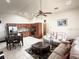 Spacious living room featuring tile flooring and a kitchen with modern stainless appliances at 2612 Shantiniketan Blvd # G12, Tavares, FL 32778