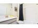 Clean bathroom featuring a bathtub, shower, vanity with a sink, and dark navy curtain at 2791 Punctuation Pl, Kissimmee, FL 34746
