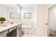 Bathroom area featuring a marble tiled tub with a double vanity sink and mirror at 2791 Punctuation Pl, Kissimmee, FL 34746