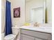 Standard bathroom with a white vanity, sink, framed mirror, and a shower with a curtain at 2791 Punctuation Pl, Kissimmee, FL 34746