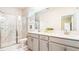 Bright bathroom with marble floors, a glass shower door, and a double sink vanity at 2791 Punctuation Pl, Kissimmee, FL 34746