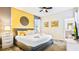Bright bedroom boasts a queen bed, decorative wall art, and en-suite bath, creating a serene retreat at 2791 Punctuation Pl, Kissimmee, FL 34746