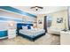 Chic bedroom features a queen bed, modern nightstands, crib and a soothing blue and gray color scheme at 2791 Punctuation Pl, Kissimmee, FL 34746