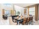 Elegant dining area with seating for eight, view into the stylish living room, and modern decor at 2791 Punctuation Pl, Kissimmee, FL 34746