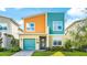 Modern two-story home featuring a colorful exterior, well-maintained landscaping, and an attached garage at 2791 Punctuation Pl, Kissimmee, FL 34746