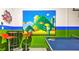 Fun game room features a ping pong table, bar seating, and playful Super Mario themed wall art at 2791 Punctuation Pl, Kissimmee, FL 34746
