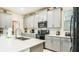 Modern kitchen with gray cabinets, stainless steel appliances, ample counter space, and bright lighting at 2791 Punctuation Pl, Kissimmee, FL 34746