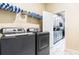 Laundry room area with a washer, dryer, and doorway leading into the kitchen at 2791 Punctuation Pl, Kissimmee, FL 34746