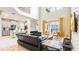 Open-concept living space with modern furnishings, kitchen view, and sliding glass doors leading to outdoor area at 2791 Punctuation Pl, Kissimmee, FL 34746