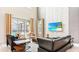 Bright living room with high ceilings, brick accent wall, stylish furniture, and sliding doors to the pool area at 2791 Punctuation Pl, Kissimmee, FL 34746