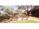 Community bocce ball court surrounded by lush trees and benches at 2810 N Powers Dr # 59, Orlando, FL 32818