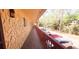 Long hallway with textured walls, red railings, and view of the parking lot and lush greenery at 2810 N Powers Dr # 59, Orlando, FL 32818