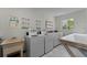 Onsite laundry facility with multiple washers, dryers, and folding table at 2810 N Powers Dr # 59, Orlando, FL 32818