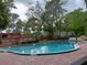 Community outdoor pool surrounded by manicured landscape at 2810 N Powers Dr # 59, Orlando, FL 32818